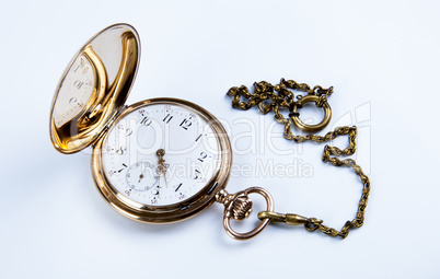 gold pocket watch on white