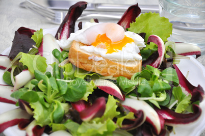 Salat mit pochiertem Ei