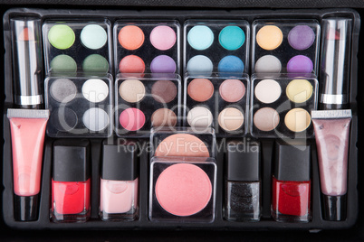 Make up case containing colorful eyeshadows, lipsticks, lip glos