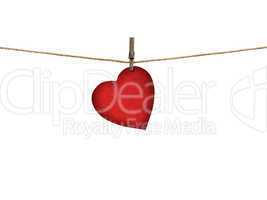 valentine card heart shaped from old red paper hanging on a clot