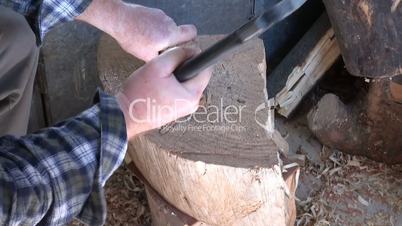 Chopping of wood with ax