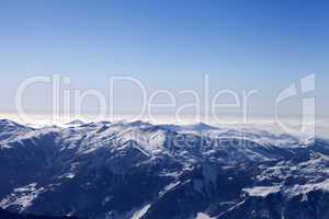 snowy mountains in haze at morning