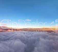 Velvet sunset above cloudscape from airplane