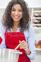 happy woman cooking in kitchen