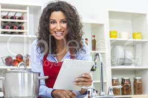 woman using tablet computer cooking in kitchen