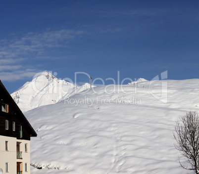 off-piste slope and hotel in winter mountains