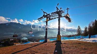 mountain landscape and skiers on a ski lift pov