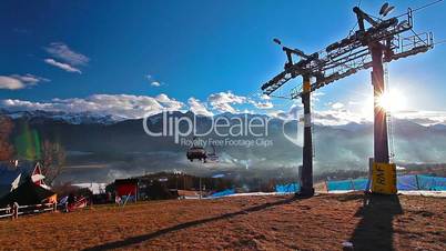 mountain landscape and skiers on a ski lift pov