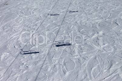 shadows from chair lift on off-piste slope