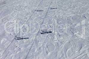 shadows from chair lift on off-piste slope