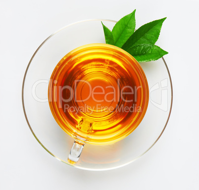 cup with tea and green leaf