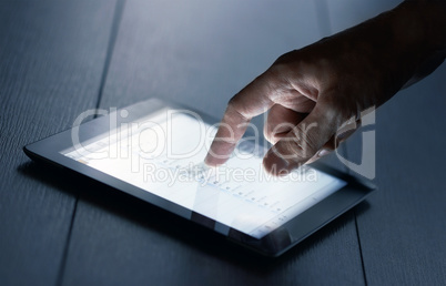 hand presses on screen digital tablet