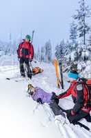 ski patrol helping woman with broken leg