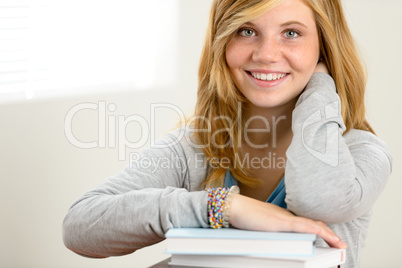 happy student girl leaning over books