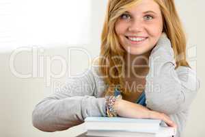 happy student girl leaning over books