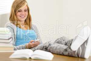 smiling student teenager relaxing legs on table