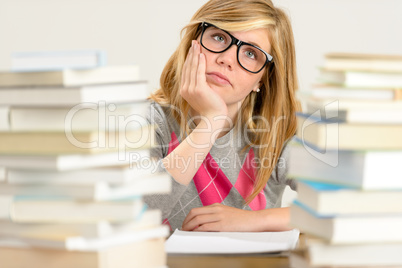 bored student girl between stack of books