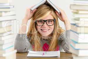 smiling student teenager holding book over head