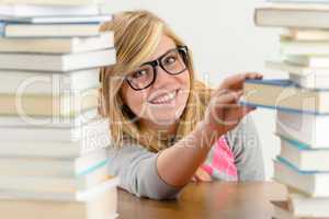 smiling student girl take book from stack