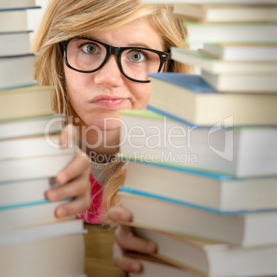 desperate student teenager look from behind books