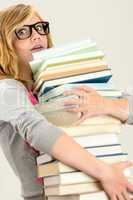 worried student girl carry stack of books