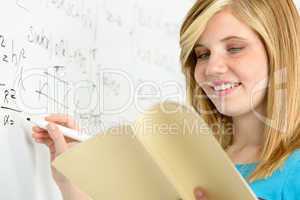 student girl writing maths on white board