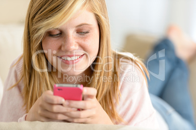 beautiful young girl texting on her cellphone