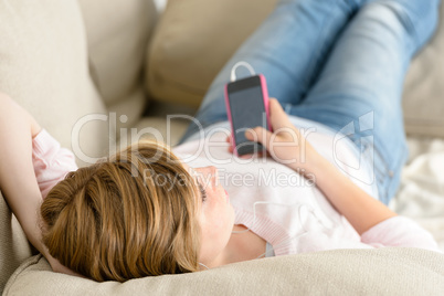 teenage woman relax on sofa listen music