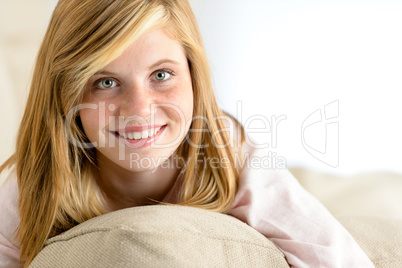 smiling beautiful teenager girl lying on pillow