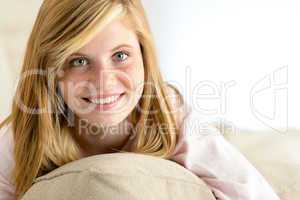 smiling beautiful teenager girl lying on pillow