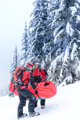 ski patrol carry injured person in stretcher