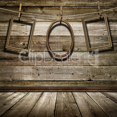 three picture frame hanging on clothespins on a background of of