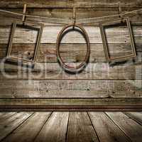three picture frame hanging on clothespins on a background of of