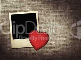 polaroid-style photo and red paper heart on a linen background