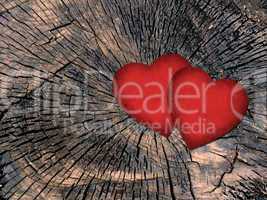 two red paper hearts on a grungy wooden background