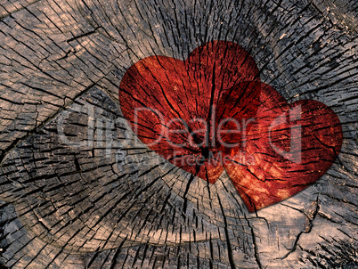 two red paper hearts on a grungy wooden background