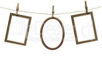 three picture frame hanging on clothespins isolated on white bac