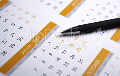black pen lying on the calendar