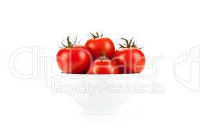white bowl of red tomatoes on a white background