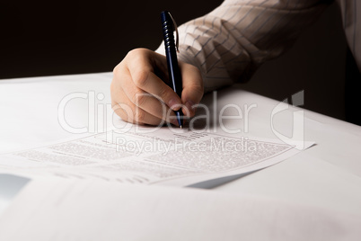 man signing a contract