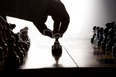 man makes a move chess figure