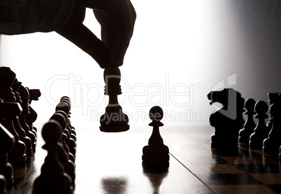man makes a move chess figure