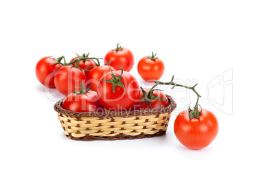 red tomatoes in a small basket on a white background