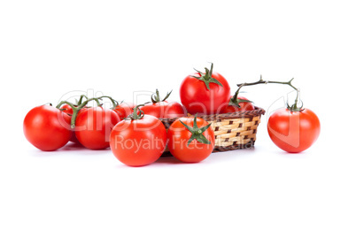 red tomatoes in a small basket on a white background