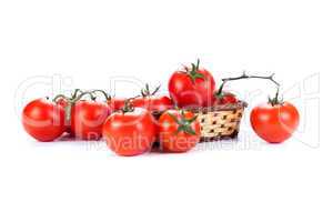 red tomatoes in a small basket on a white background