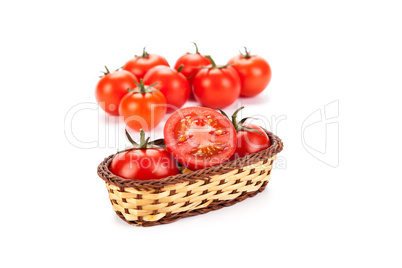 red tomatoes in a small basket on a white background