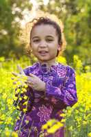 african american girl child in field of yellow flowers