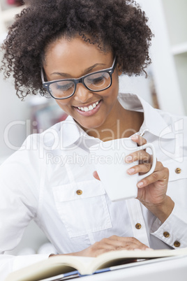 african american woman drinking coffee reading book