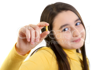 young girl holding capsule