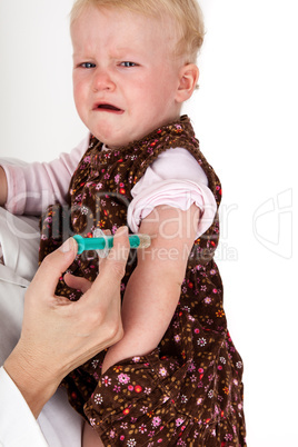 doctor injects small child in her arms